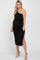 woman wearing a black one-shoulder maternity dress with a tie waist and side slit, showing her baby bump