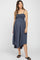 pregnant woman wearing a navy blue smocked maternity midi dress with spaghetti straps and black sandals