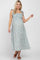 woman wearing a light blue floral maternity maxi dress with tie straps and a visible baby bump