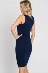 woman wearing a navy blue sleeveless ribbed bodycon dress, showing a fitted silhouette from the back