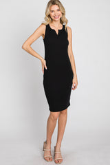 woman wearing a black sleeveless ribbed midi dress with a keyhole neckline and strappy beige heels
