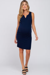 woman wearing a navy blue sleeveless maternity dress with a v-neck and visible baby bump