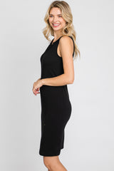 smiling woman with blonde hair wearing a sleeveless black ribbed midi dress against a white background