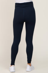 woman wearing navy blue maternity leggings with a high waist and a fitted style