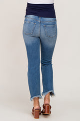 woman wearing a pair of light blue maternity jeans with a frayed hem, viewed from the back.