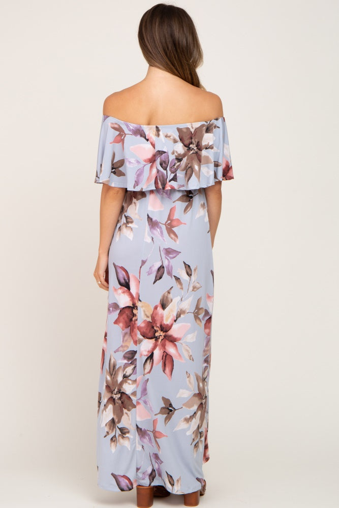 woman wearing a light blue floral off-the-shoulder maternity maxi dress with ruffle detail and a flowing fit