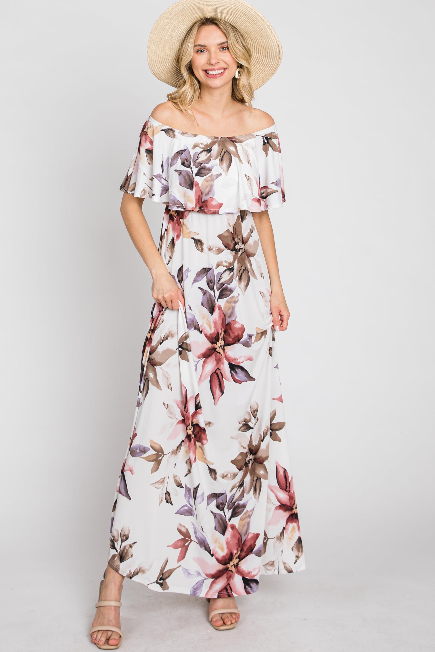 woman wearing a floral off-the-shoulder maxi dress with ruffle sleeves and a wide-brimmed hat