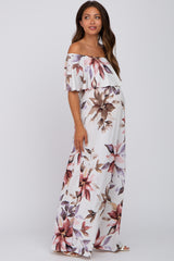 woman wearing a floral off-the-shoulder maternity maxi dress with a flowing design and visible baby bump