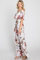 woman wearing a floral off-the-shoulder maxi dress with ruffle sleeves and a straight silhouette, standing sideways