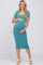 smiling pregnant woman wearing a teal short sleeve maternity midi dress and beige sandals
