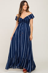 woman wearing a navy striped off-the-shoulder maternity maxi dress with a cinched bodice and ruffled hemline