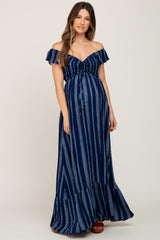 woman wearing a navy and white striped off-the-shoulder maternity maxi dress with gathered front and ruffle hem, showing baby bump