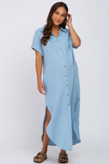 woman wearing a light blue maternity button-up dress with short sleeves and a side slit, showing her baby bump