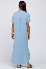 woman wearing a light blue maternity maxi dress with short sleeves and a back pleat