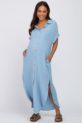 woman wearing a light blue maternity button-up dress with short sleeves and pockets, featuring side slits