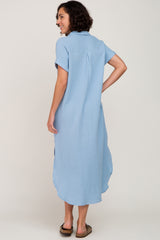 woman wearing a light blue short sleeve midi dress with a relaxed fit and back pleat detail