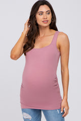 Pregnant woman wearing a mauve scoop neck maternity tank top with side ruching and distressed jeans
