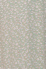 close up of sage green fabric with small white and blue floral ditsy print