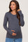 Pregnant woman wearing a charcoal grey long sleeve maternity top with thumbholes and blue jeans