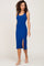 woman wearing a blue ribbed midi dress with a side slit and thin straps