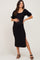 pregnant woman wearing a black ribbed maternity midi dress with puff sleeves and side slit