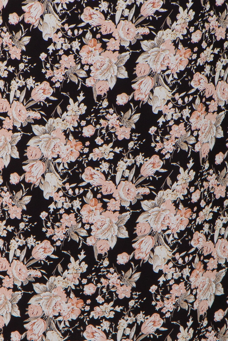 Close up of black fabric with a vintage pink and beige floral pattern featuring roses and tulips