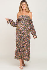 woman wearing a floral off-the-shoulder maxi maternity dress with long sleeves and visible baby bump