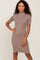 Woman with curly hair wearing a mauve short sleeve mock neck ribbed knit midi dress