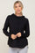 woman wearing a black long sleeve hooded top with drawstrings and grey leggings