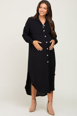 smiling pregnant woman in a black button down maternity midi dress and tan ankle boots
