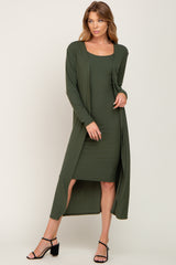 woman wearing olive green ribbed midi dress and matching long cardigan with black heels
