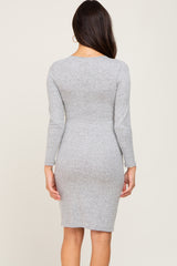 back view of a woman wearing a long sleeve grey heathered knit bodycon dress