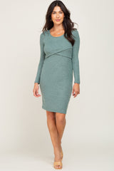 woman wearing a long sleeve sage green maternity nursing dress with a wrap front detail