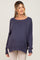 woman wearing a navy blue oversized maternity sweater with a wide neckline and long sleeves, featuring a relaxed fit