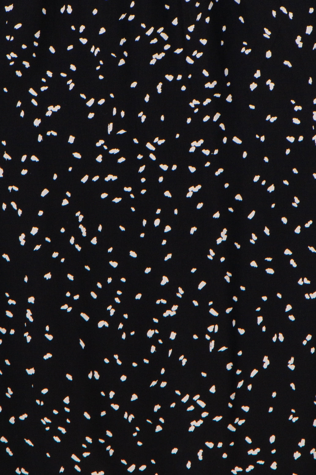 close up of black fabric with white abstract speckle pattern