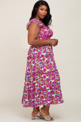 woman wearing a floral plus-size maxi dress with ruffled straps and a tiered skirt