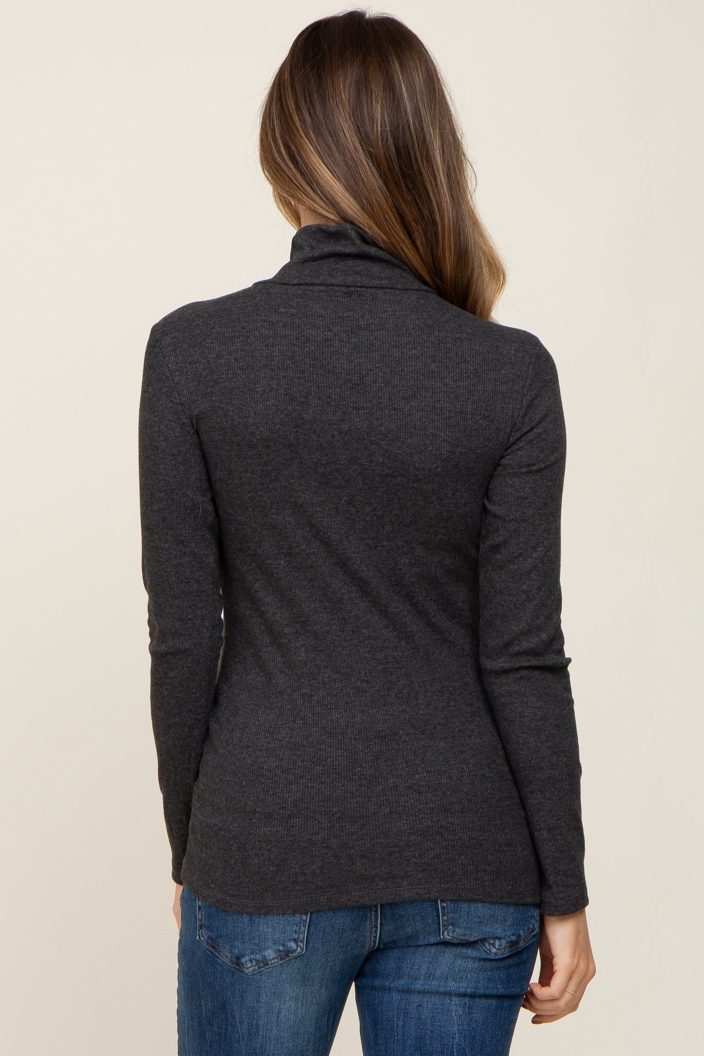 woman wearing a dark gray long sleeve maternity top from the back with a fitted style and soft fabric