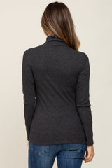 woman wearing a dark gray long sleeve maternity top from the back with a fitted style and soft fabric