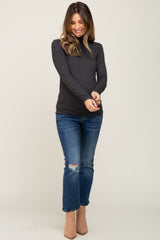 woman wearing a dark gray maternity long sleeve top with jeans and tan ankle boots
