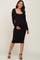 woman wearing a black long sleeve maternity dress and gently holding her baby bump