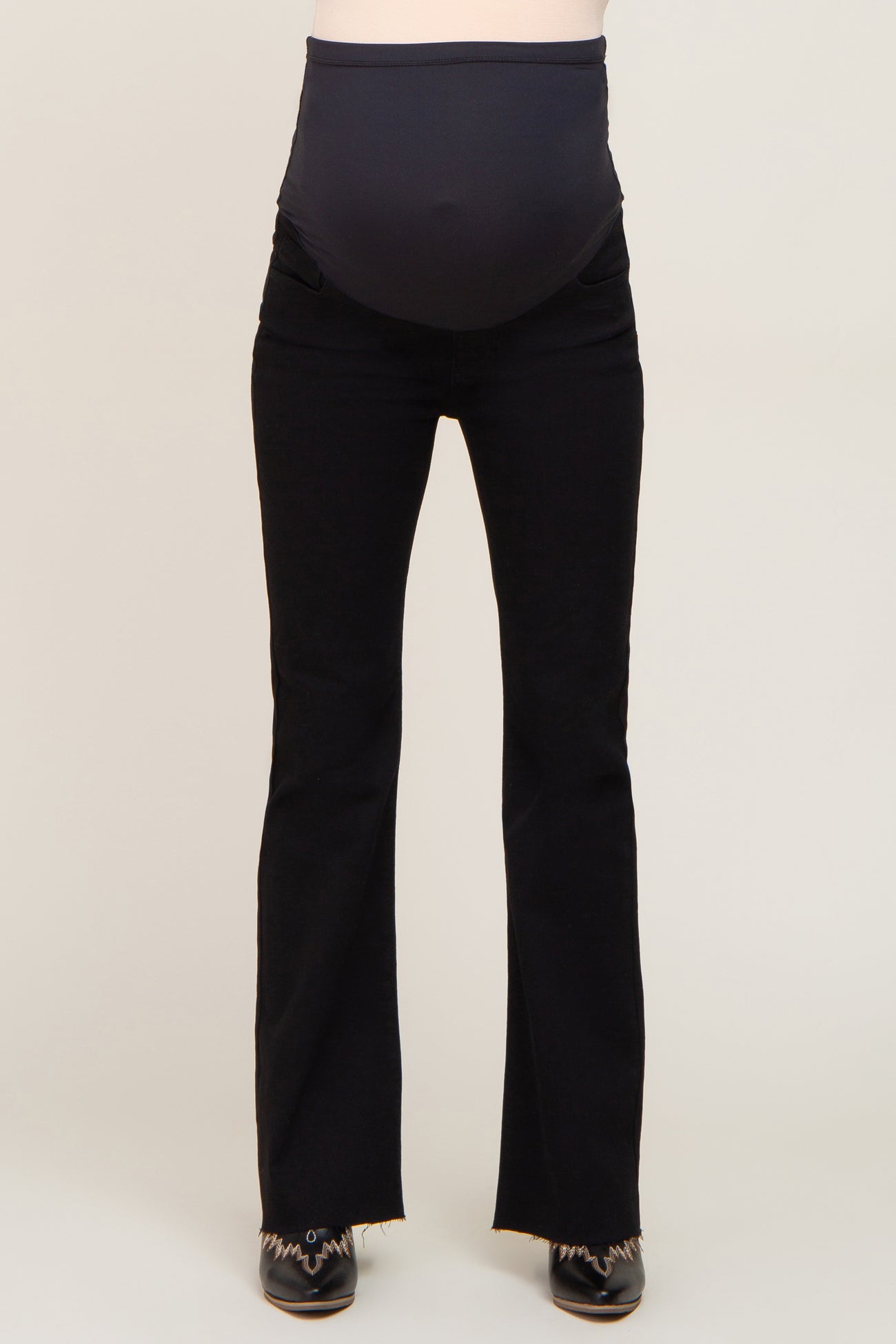 maternity wear black flared jeans with a stretchy waistband designed for a baby bump