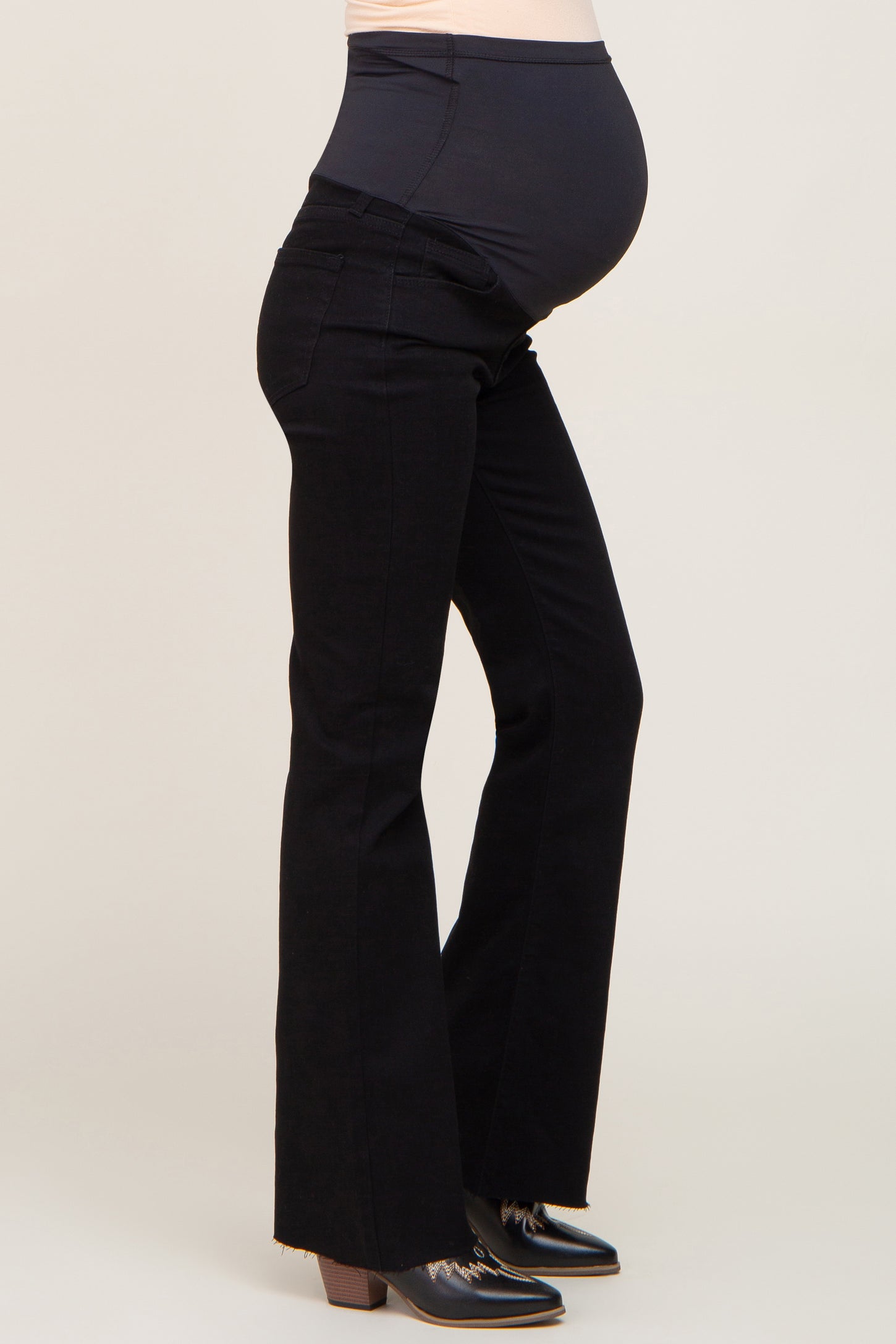 maternity wear black flared jeans with a supportive waistband and visible baby bump