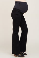 maternity wear black flared jeans with a supportive waistband and visible baby bump