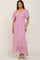 Woman wearing a pink floral smocked maxi dress with flutter sleeves and square neckline