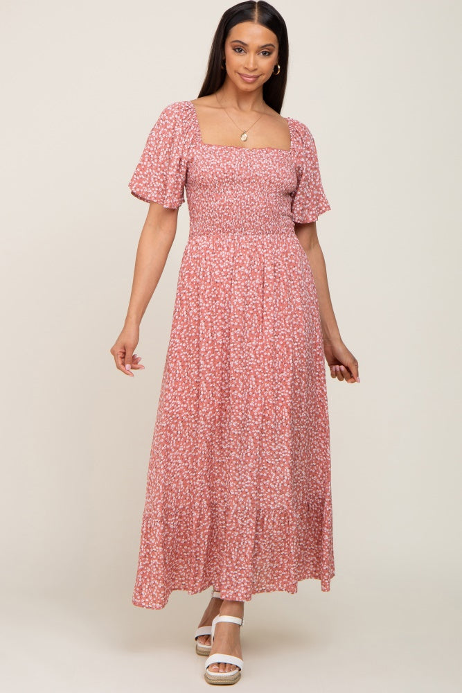 woman wearing a pink floral maxi dress with puff sleeves and a square neckline