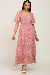 woman wearing a pink floral maxi dress with puff sleeves and a square neckline