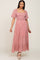woman wearing a pink floral maxi dress with puff sleeves and a square neckline