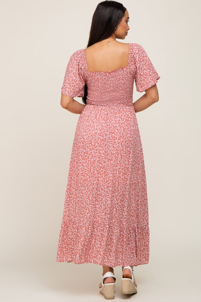 woman wearing a pink floral smocked back maxi dress with short puff sleeves and white wedge sandals