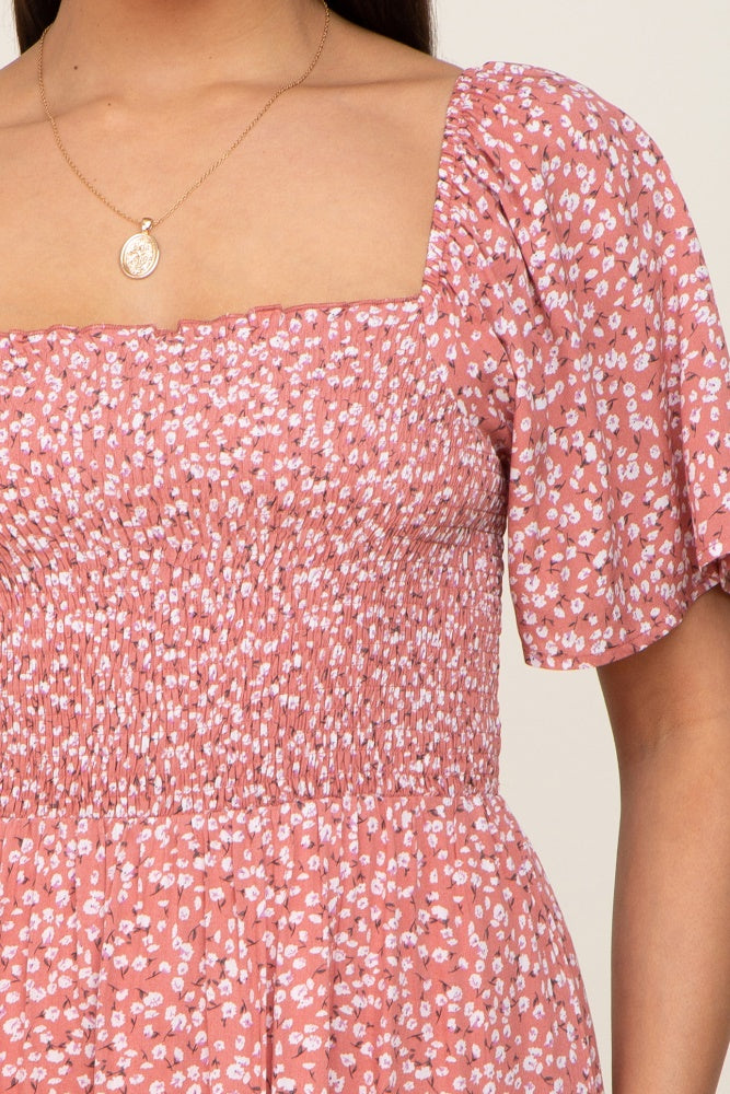 close-up of a woman wearing a pink floral puff sleeve dress with a square neckline and smocked bodice