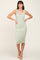 woman wearing a striped midi tank dress in green and cream with a fitted silhouette and side pockets
